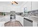 Bright kitchen features white cabinets, stainless steel appliances, and tile flooring at 2861 Pinellas Point S Dr, St Petersburg, FL 33712