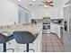 Modern kitchen with sleek countertops, stainless steel appliances, white cabinetry and a breakfast bar at 2861 Pinellas Point S Dr, St Petersburg, FL 33712