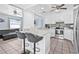 Kitchen with breakfast bar featuring marble countertops, stainless steel appliances, and modern finishes at 2861 Pinellas Point S Dr, St Petersburg, FL 33712