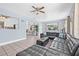 Spacious living room features tile flooring, neutral walls, plenty of natural light, and a leather sectional at 2861 Pinellas Point S Dr, St Petersburg, FL 33712