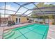 Screened-in pool with jacuzzi, patio furniture and a view of the home with double doors at 2861 Pinellas Point S Dr, St Petersburg, FL 33712