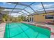 Screened-in pool with jacuzzi, patio furniture, and a view of the house with patio doors at 2861 Pinellas Point S Dr, St Petersburg, FL 33712