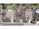 Overhead view of three homes, highlighting their landscaping and neighborhood layout at 304 Caloosa Palms Ct, Sun City Center, FL 33573