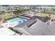 A view of the amenities in Sun City Center include a pool, clubhouse, lawn bowling, parking, and lush greenery at 304 Caloosa Palms Ct, Sun City Center, FL 33573