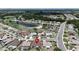 Overhead view of a residential neighborhood, showcasing the layout and proximity to a lake at 304 Caloosa Palms Ct, Sun City Center, FL 33573