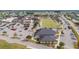 Aerial view of the community amenities featuring lawn bowling, a clubhouse, ample parking, and well-maintained landscaping at 304 Caloosa Palms Ct, Sun City Center, FL 33573