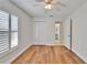 A brightly lit bedroom with wood-look floors and a double door closet at 304 Caloosa Palms Ct, Sun City Center, FL 33573