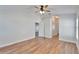A well-lit bedroom featuring wood-look floors, a ceiling fan, and white walls at 304 Caloosa Palms Ct, Sun City Center, FL 33573