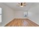 Bedroom features wood-look floors, a ceiling fan, and two shuttered windows at 304 Caloosa Palms Ct, Sun City Center, FL 33573