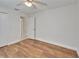 Bright bedroom features wood-look floors and an open door to a tiled hallway at 304 Caloosa Palms Ct, Sun City Center, FL 33573