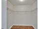 A walk-in closet with wood-look flooring and a metal shelving system at 304 Caloosa Palms Ct, Sun City Center, FL 33573