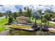 Sun City Center entrance with lush landscaping, mature palm trees, manicured lawn, water feature, and iconic Sun City sign at 304 Caloosa Palms Ct, Sun City Center, FL 33573