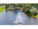A sunny Sun City Center entrance featuring a serene lake, iconic signage, fountain, and lush greenery for a warm welcome at 304 Caloosa Palms Ct, Sun City Center, FL 33573
