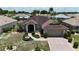 Beautiful aerial view of a well-maintained single-story home with lush landscaping and a spacious driveway at 304 Caloosa Palms Ct, Sun City Center, FL 33573