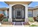 Inviting front entrance with screen door, featuring neutral tones and charming landscaping at 304 Caloosa Palms Ct, Sun City Center, FL 33573