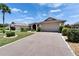 Charming Sun City Center home with a well-manicured lawn, mature landscaping, and an inviting front entrance with covered porch at 304 Caloosa Palms Ct, Sun City Center, FL 33573
