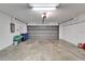 Spacious garage featuring a garage door, lighting, and ample room for storage at 304 Caloosa Palms Ct, Sun City Center, FL 33573