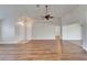 Open-concept living area with wood-look floors, vaulted ceilings, and plenty of natural light at 304 Caloosa Palms Ct, Sun City Center, FL 33573