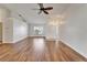 Bright and airy living room with wood-look floors, ceiling fan, and ample natural light at 304 Caloosa Palms Ct, Sun City Center, FL 33573