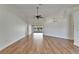 Spacious living room with vaulted ceilings, ceiling fans, and wood-look flooring at 304 Caloosa Palms Ct, Sun City Center, FL 33573
