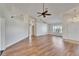 Open-concept living area featuring vaulted ceilings, wood flooring, and a bright, inviting atmosphere at 304 Caloosa Palms Ct, Sun City Center, FL 33573