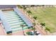 Aerial view of shuffleboard courts with players, palm trees, benches, and golf carts nearby at 304 Caloosa Palms Ct, Sun City Center, FL 33573