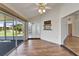 Cozy sun room with access to the lanai, featuring tile floors and a serving pass-through at 304 Caloosa Palms Ct, Sun City Center, FL 33573