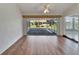 Bright sun room with tile flooring, offering serene views of the landscaped backyard at 304 Caloosa Palms Ct, Sun City Center, FL 33573