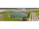 An aerial view showcases the community ponds and construction progress, near the shopping centers and roadways at 308 Mangrove Shade Cir, Apollo Beach, FL 33572