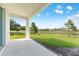 View of covered back patio and yard backing to a pond at 308 Mangrove Shade Cir, Apollo Beach, FL 33572