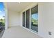 View of the covered back patio with sliding glass door into the home at 308 Mangrove Shade Cir, Apollo Beach, FL 33572