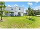 View of expansive backyard with well-maintained lawn, perfect for outdoor activities at 308 Mangrove Shade Cir, Apollo Beach, FL 33572