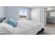Sunlit bedroom features a window and comfortable bed with the bathroom adjacent at 308 Mangrove Shade Cir, Apollo Beach, FL 33572