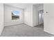 A bright bedroom boasts neutral carpet, white walls and a window at 308 Mangrove Shade Cir, Apollo Beach, FL 33572
