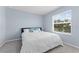 Bright bedroom featuring a bed with blue accents and a window providing natural light at 308 Mangrove Shade Cir, Apollo Beach, FL 33572