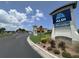 Entrance to the community, featuring an Aldi grocery store, set against a bright sky and lush landscaping at 308 Mangrove Shade Cir, Apollo Beach, FL 33572