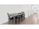 A dining area features a table with four chairs and tile flooring at 308 Mangrove Shade Cir, Apollo Beach, FL 33572