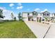 New construction townhome featuring a two-car garage, and neutral colored exteriors at 308 Mangrove Shade Cir, Apollo Beach, FL 33572