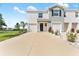 Two-story townhome featuring a large driveway, two-car garage, and simple landscaping for curb appeal at 308 Mangrove Shade Cir, Apollo Beach, FL 33572