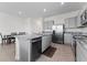Kitchen featuring gray cabinets, granite countertops, and stainless appliances at 308 Mangrove Shade Cir, Apollo Beach, FL 33572