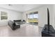 Living room with sliding doors to the patio and a comfortable gray sectional at 308 Mangrove Shade Cir, Apollo Beach, FL 33572