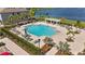 Community pool featuring lounge chairs, shade features, and tropical landscaping at 308 Mangrove Shade Cir, Apollo Beach, FL 33572