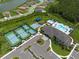 A stunning aerial view of the community amenities, including tennis courts and a luxurious pool area at 3144 Mountain Spruce Ter, Wesley Chapel, FL 33543