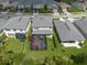An aerial view of a home with a screened patio, and a well-maintained lawn at 3144 Mountain Spruce Ter, Wesley Chapel, FL 33543