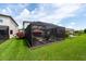 Spacious backyard with screened-in patio, offering an ideal space for outdoor gatherings at 3144 Mountain Spruce Ter, Wesley Chapel, FL 33543