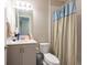 Bright bathroom featuring a stylish vanity and a shower with a patterned shower curtain at 3144 Mountain Spruce Ter, Wesley Chapel, FL 33543