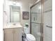 Clean bathroom with tiled shower featuring glass doors, and a modern vanity at 3144 Mountain Spruce Ter, Wesley Chapel, FL 33543