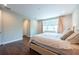 Bright bedroom with hardwood floors, natural light, and ensuite bathroom entrance at 3144 Mountain Spruce Ter, Wesley Chapel, FL 33543