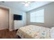 A bedroom featuring wood floors, natural light, a queen-size bed, and neutral decor at 3144 Mountain Spruce Ter, Wesley Chapel, FL 33543