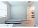 Spare bedroom with a basic bed, wood floors, and a view into an adjacent room at 3144 Mountain Spruce Ter, Wesley Chapel, FL 33543